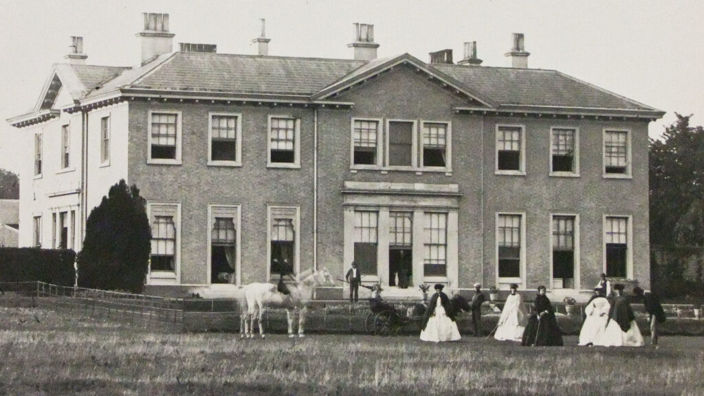 Playing croquet on the lawn in the 19th century at Hemingford Park